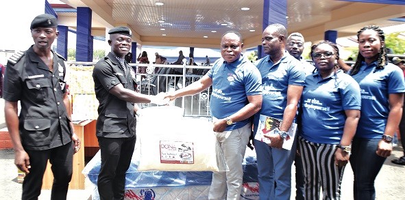 Patrick Chrapah, Marketing Manager of Latex Foam, presenting the Latex Foam Best Recruit Award to Samuel Asamoah Amponsah (2nd from left) at the passing out parade. With them are some officials  of Latex Foam and a police officer. Picture: EDNA SALVO-KOTEY